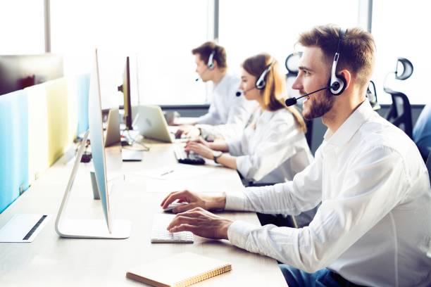 istock Happy young male customer support executive working in office. 1212957482