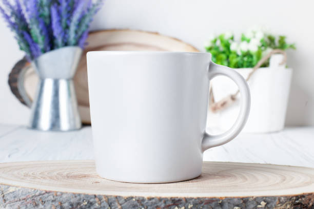istock White mug on a background of flowers . Mock up. Template Space for creative artwork. Lettering text product promotion branding. 1212959229