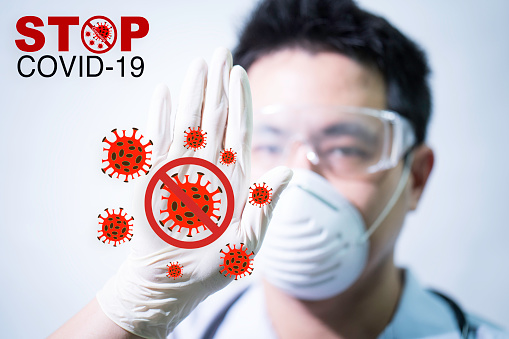 Stop COVID-19 concept. The male doctor is making a stop sign to stop the virus by hand. Doctors holding Coronavirus 2019-nCoV Stop that cause mysterious viral in China (Wuhan City)