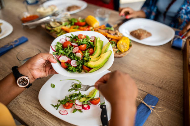 Unrecognizable person taking salad