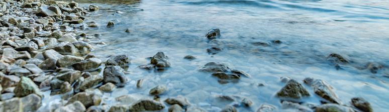 Abstract blur shore water and rocks