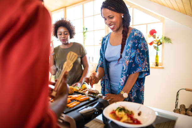 istock African female friends preparing food 1212962876