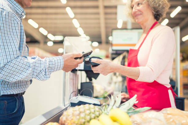 istock Paying out with mobile phone in the supermarket 1212964738