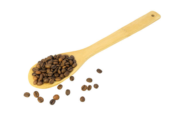 istock Wooden spoon with coffee beans isolated on a white background 1212966400