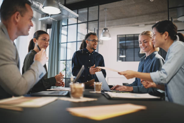 istock Young businessman talking with staff during an office meeting 1212966771