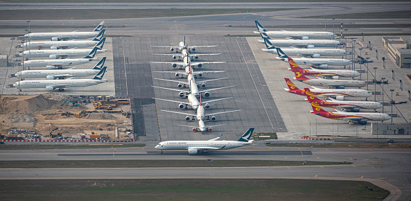 March 16, 2020, Hong Kong: An airplane is seen on the runway of Hong Kong International Airport while other aircrafts are lined up on the tarmac.