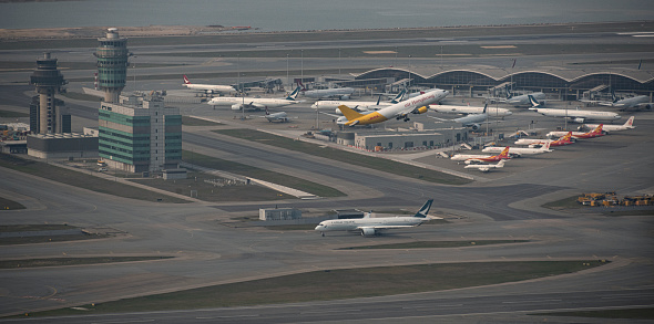 March 16, 2020, Hong Kong: An airplane is seen taking off from Hong Kong International Airport while other aircrafts are lined up on the tarmac.