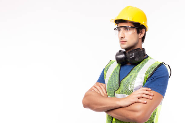 istock Engineer or worker in hardhat, safety vest, safety glasses in factory or site work. Engineer or professional contractor cross arm, look to copy space. Business engineer guy get successful of business 1212968948