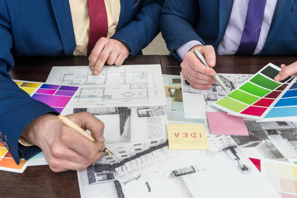 istock design team working at office under house project. Apartament scetch with color palette 1212969548