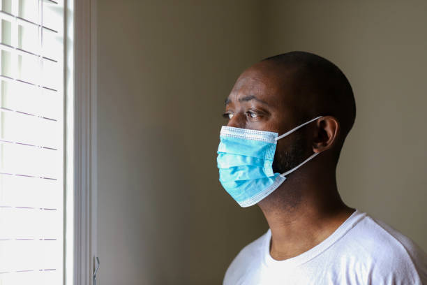 An African-American man wearing a protective face mask to prevent virus infection stock photo