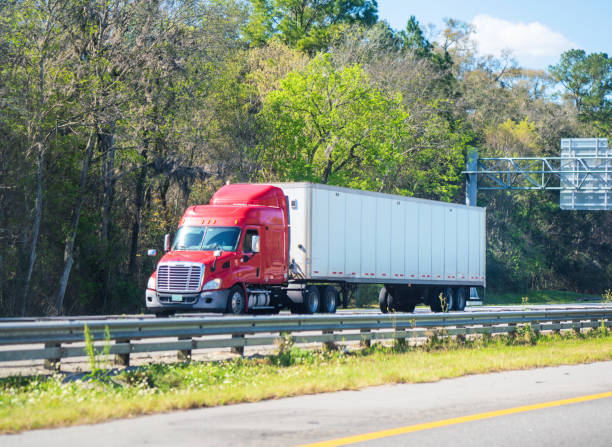 istock Red and white semi truck Florida highway 1212972632