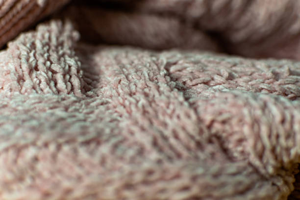 istock Fine textured and voluminous fabric in pink. Embossed textile pattern, pleasant to the touch and delicate 1212974315