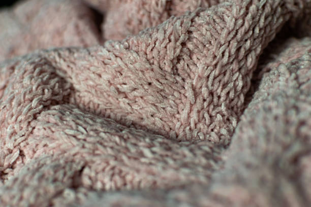 istock Fine textured and voluminous fabric in pink. Embossed textile pattern, pleasant to the touch and delicate 1212975460