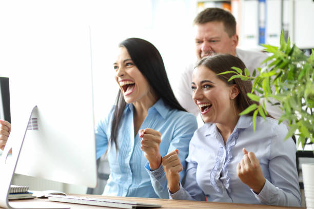 istock Small team employees emotionally watching events. 1212975532