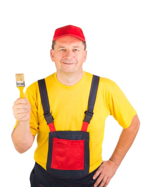 istock Worker shows painting brush. 1212976008