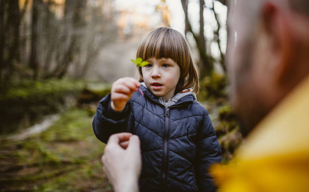 istock Toddler boy discovering nature with his parent 1212977521
