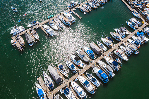 Charging station for boats. Electric sockets for charging ships in the harbor on a pier near the sea coast. Charging the yacht from the power station in the marina. Smart marine pedestal.