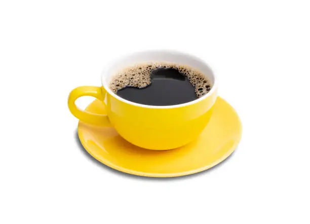 Photo of cutout Italian style hot black coffee with heart-shaped froth in the yellow coffee cup isolated on white background top view with clipping path