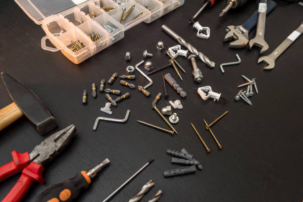 istock set of different tools with drill bits, screws, screwdriver bits and hexagon wrench for repair on black desk 1212979230
