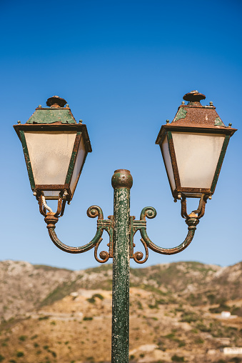 Rusty old street lamp on a sunny day