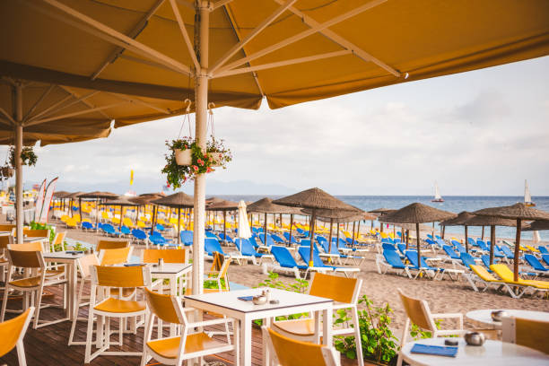 istock Umbrellas and sun beds on the sandy beach of Rhodes 1212979310