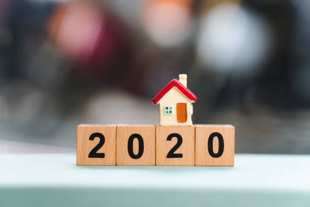 istock Mini house on wooden block year 2020 1212980699