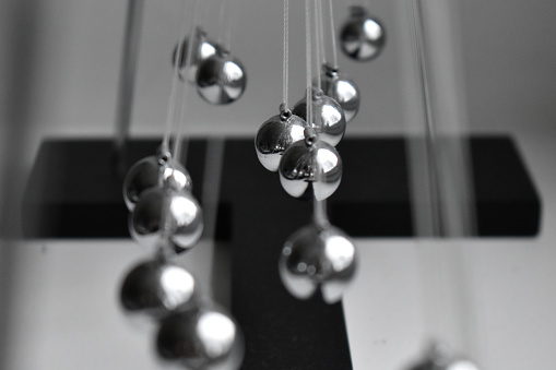 Business concept for strategy team work and alignment. Newtons Cradle Pendulum.