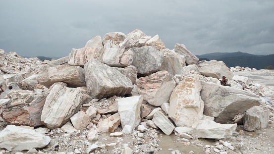 Stones of a marble mountain against the gloomy sky.