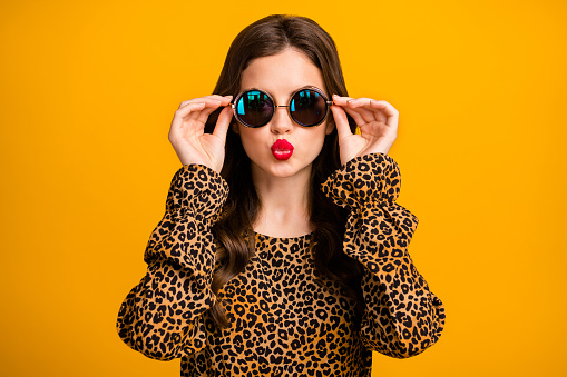 Close-up portrait of her she nice attractive lovely pretty glamorous, wavy-haired girl touching specs sending air kiss isolated on bright vivid shine vibrant yellow color background