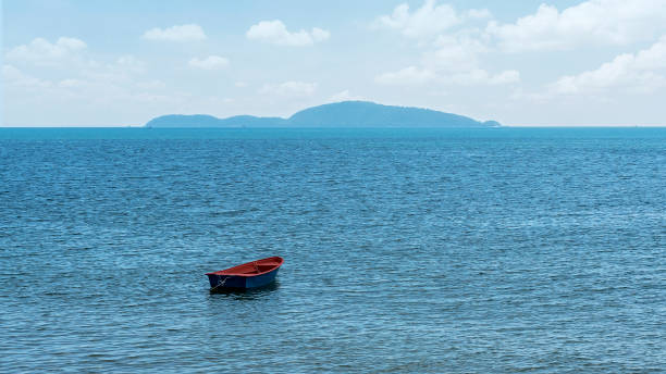 Beautiful sea view, and a small boat floating in the middle of the sea