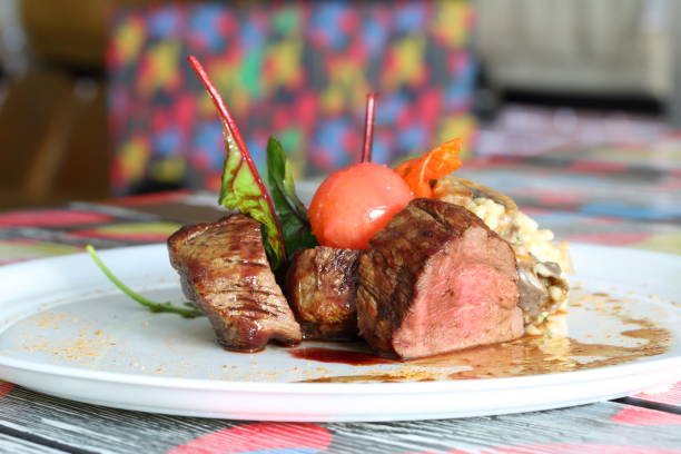 istock Steak with cherry tomatoes on a white plate 1212982847