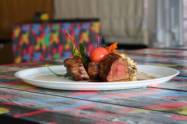 istock Steak with cherry tomatoes on a white plate 1212983500