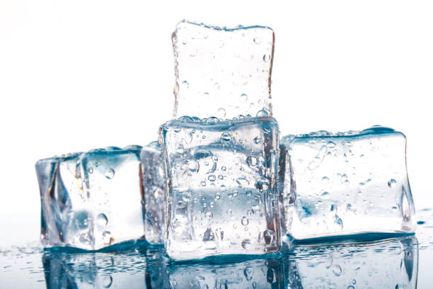 istock ice cubes and water drops close up on blue and white background 1212983564