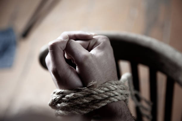 man hands tied on dark background man hands tied on dark background torture photos stock pictures, royalty-free photos & images