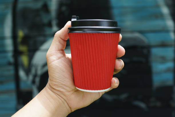istock Hand holding a paper coffee cup 1212984390