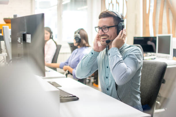 istock Dispatcher listening to a client using hands-free headset at his workplace in call center 1212984608