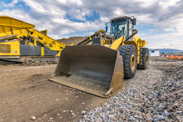 istock Excavator in a quarry extracting stone and rock 1212984786