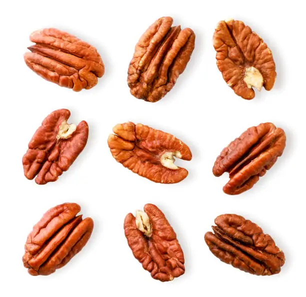 Peeled pecan nuts close-up on a white background. Isolated