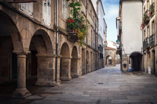 Pedestrian street and historic building facades in old town Santiago de Compostela, Galicia, Spain.