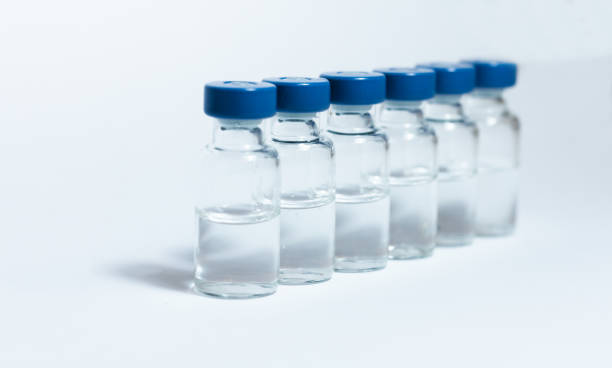 Glass medicine bottles with injection fluid with blue aluminium caps for vaccination. Coronavirus epidemic, Cancer, painand diabetes treatment, pharmaceutical medicine concept Glass medicine bottles with injection fluid with blue aluminium caps for vaccination. Coronavirus epidemic, Cancer, painand diabetes treatment, pharmaceutical medicine concept crista ampullaris photos stock pictures, royalty-free photos & images