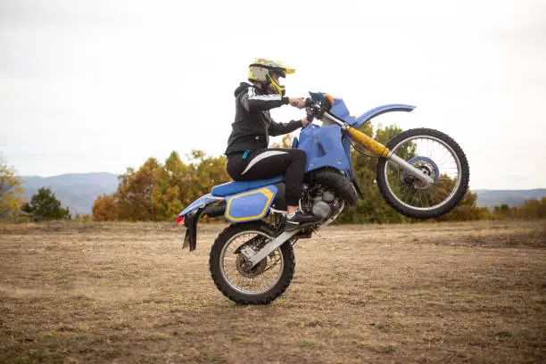 Extreme sports athlete riding his enduro motorbike on a mountain dirt road in Serbia