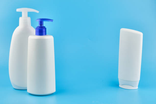 istock Three man skin care generic product tubes isolated on blue background with copy space 1212988053