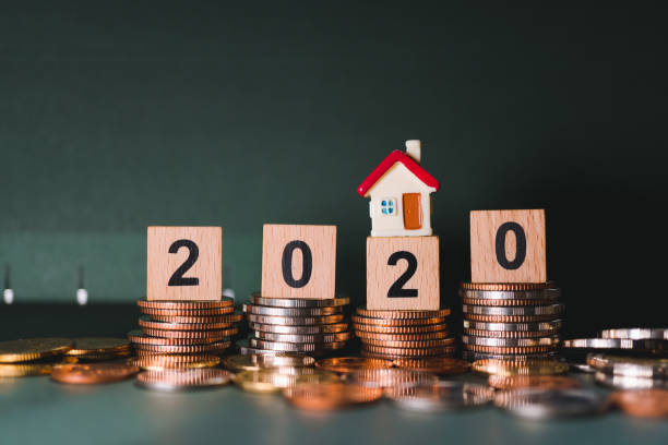 istock Wooden block year 2020 and mini house 1212988497