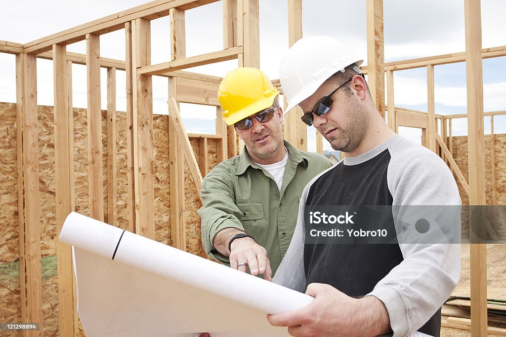 Construction Contractors building a new home  Hardhat Stock Photo