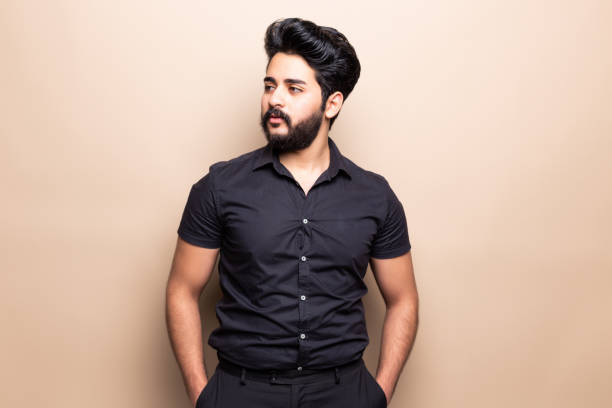 istock Young bearded man standing isolated on beige background 1212990579