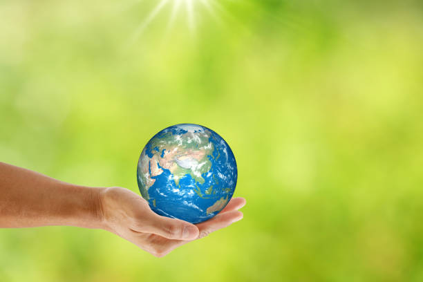 istock Hand holding the earth on natural bokeh background. save the earth concept. 1212991108