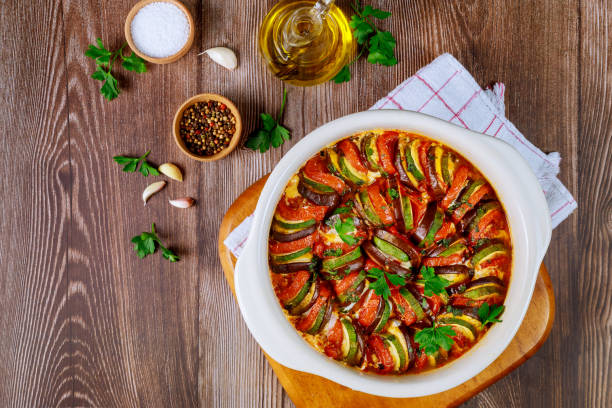 istock Stewed vegetable ratatouille with mozzarella cheese in white oven pan. 1212991219