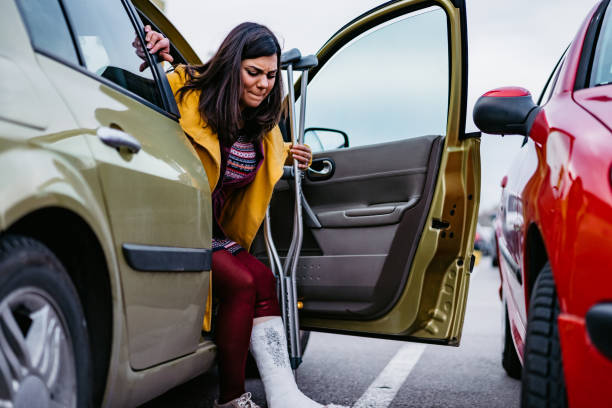 istock Woman with cast getting out of car 1212992289