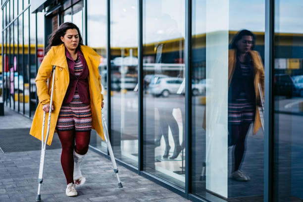 istock Woman window shopping with cast on foot 1212992670