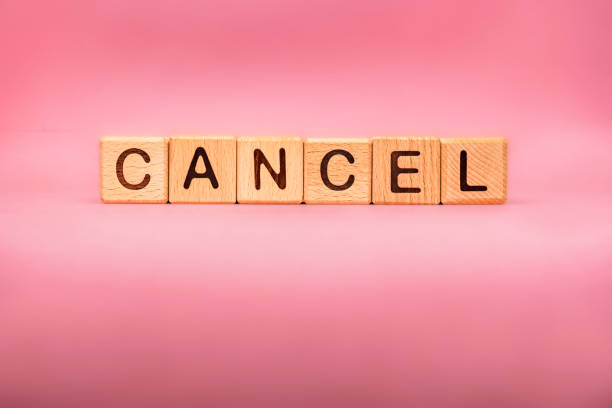 istock CANCEL word made with building blocks, business concept. Word CANCEL on pink background. 1212992703